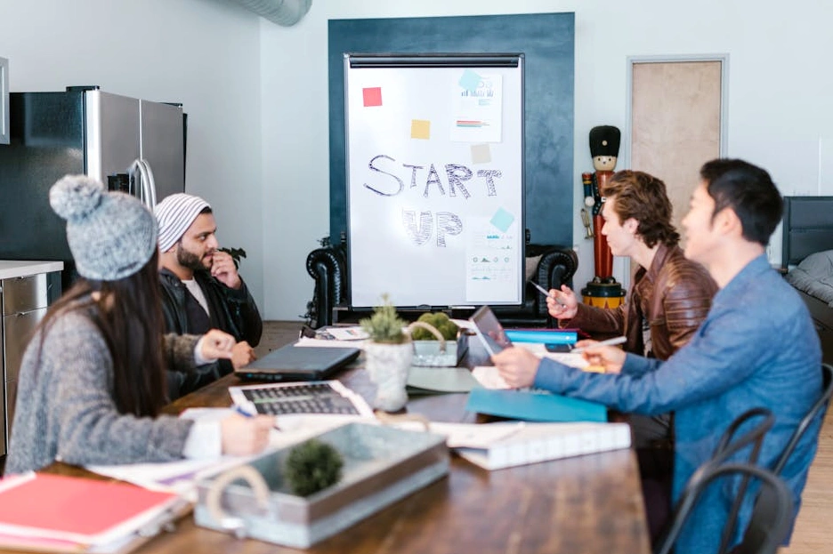A diverse team of marketing professionals collaborating around a table in a modern office.